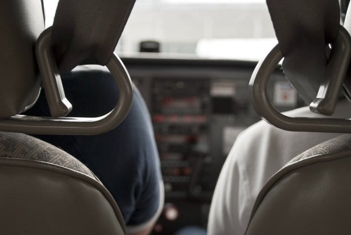 View between two pilot seats facing the controls.