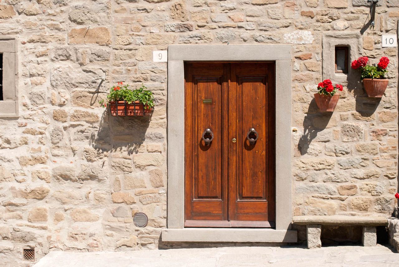 Doorway to a Cortona home decorated with flowers