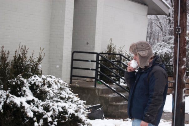 John Spade eats a snowball.