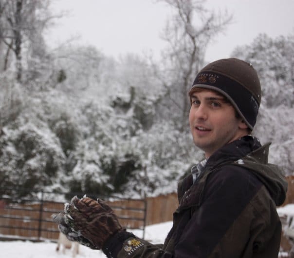 Chris makes a snowball.