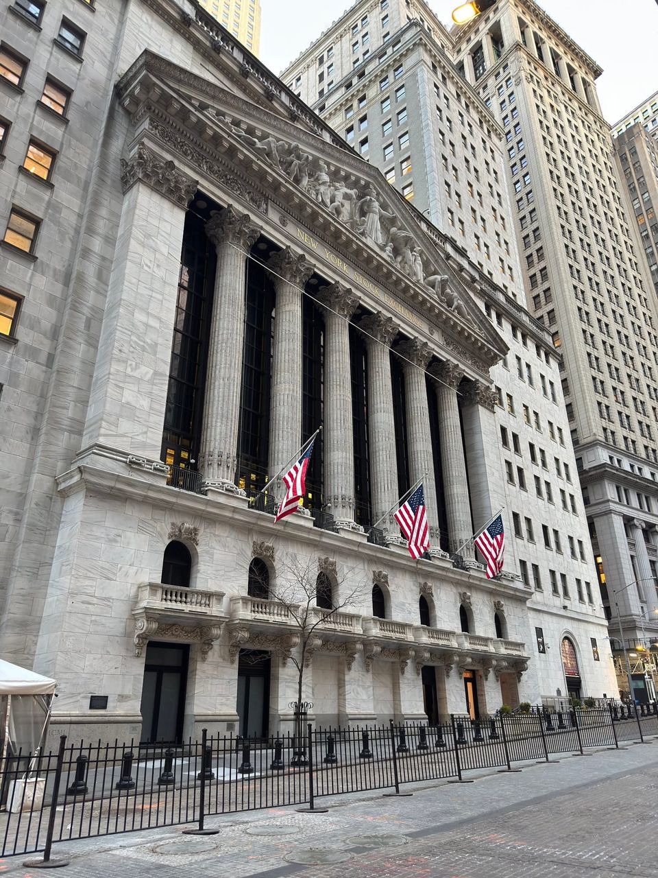 New York Stock Exchange facade with columns and three American flags